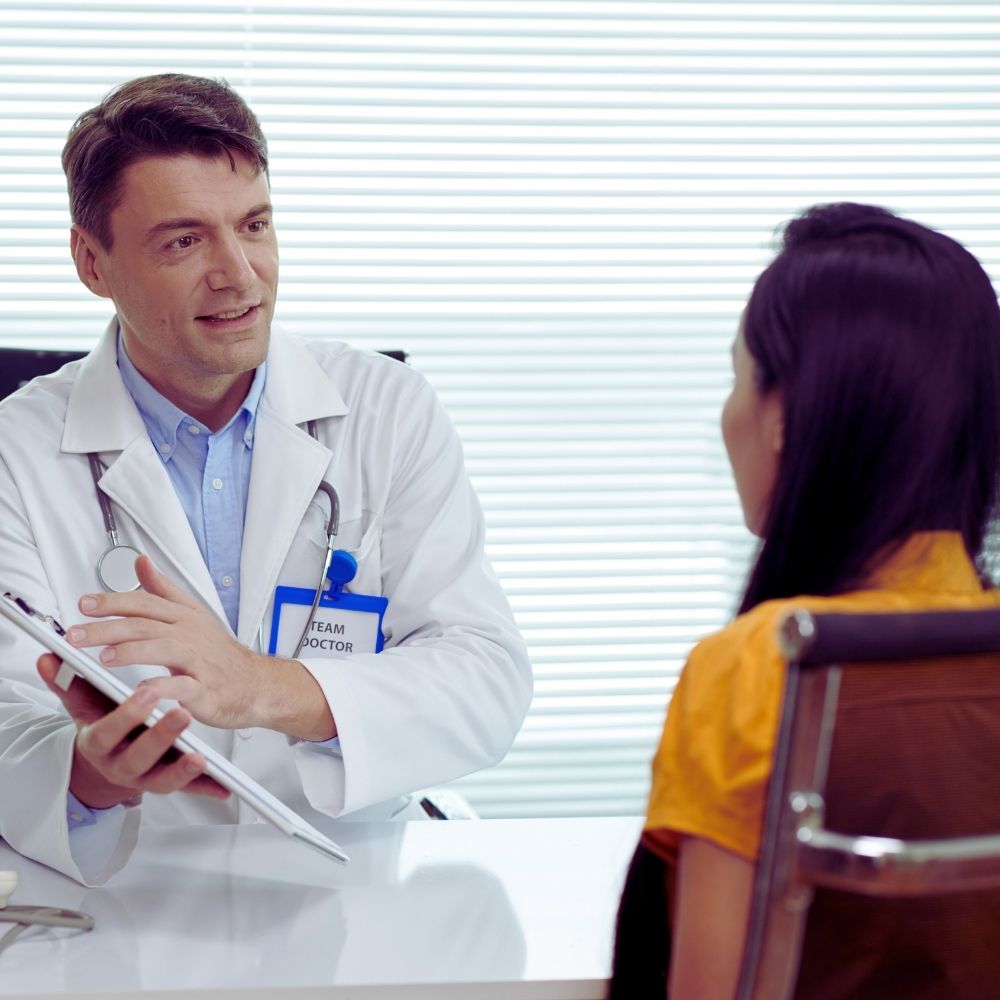 A doctor reviewing a Short Term Medical Plan Insurance with a patient